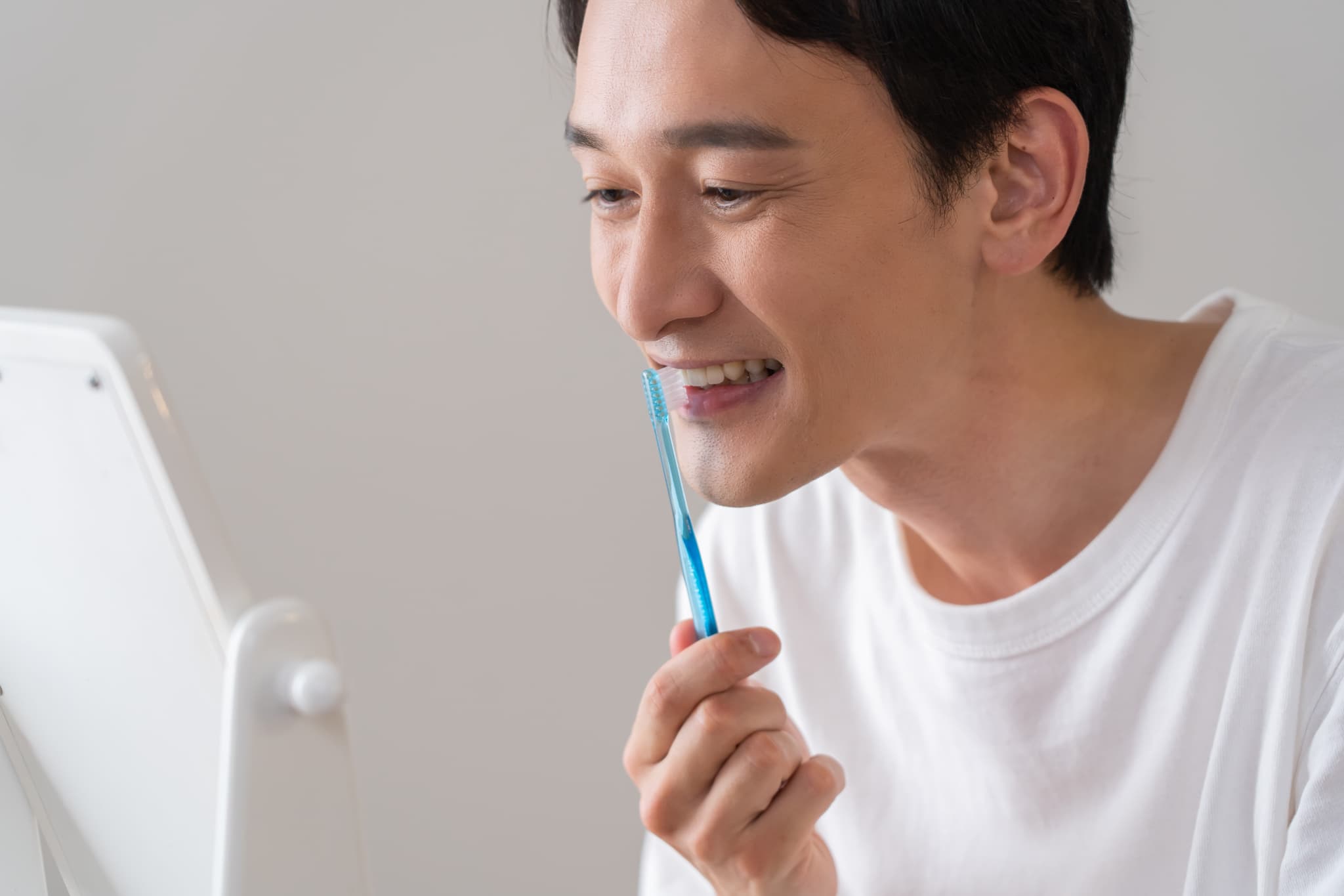丁寧に1本1本歯磨きする男性