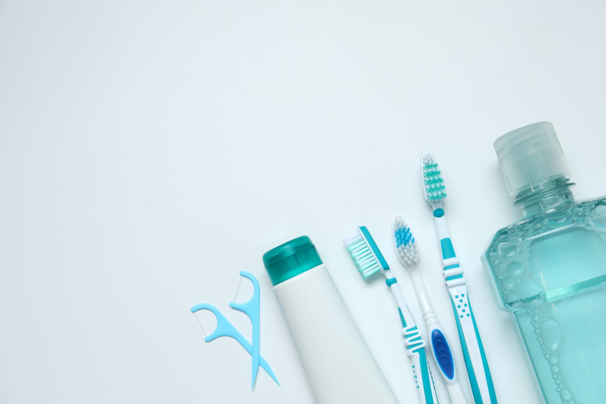 歯ブラシやデンタルフロスで口腔ケアを徹底するイメージ